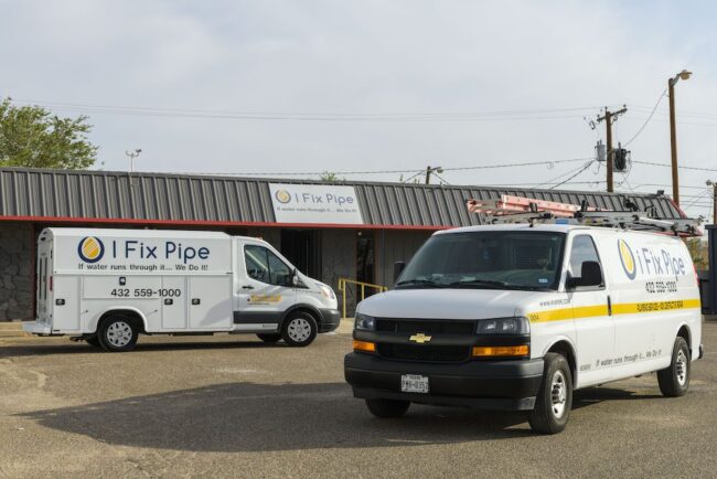 I Fix Pipe service vehicles parked outside the I Fix Pipe plumbing office, showcasing the brand and contact information relevant to plumbing services.