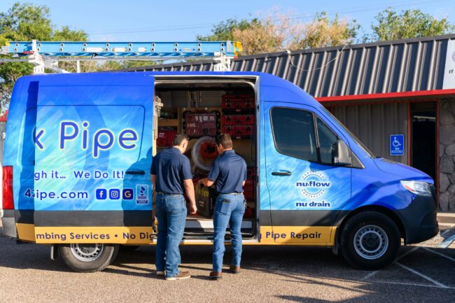 I Fix Pipe service van with technicians preparing equipment for trenchless pipe repair, showcasing plumbing services and modern technology.